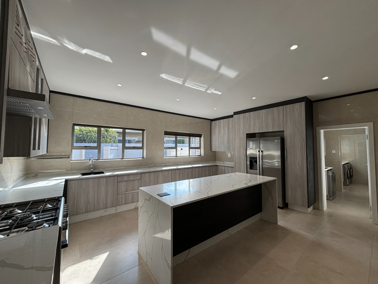 Premium residential kitchen with fitted cabinetry and a central island after refurbishment