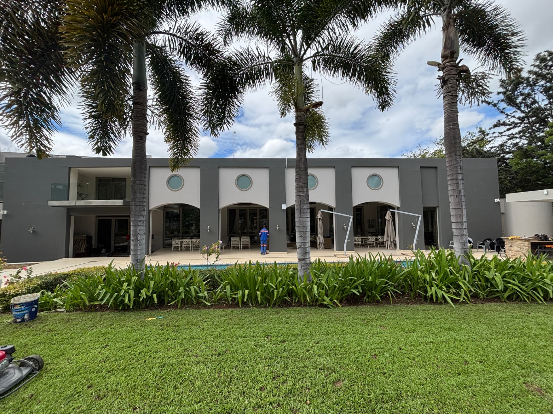 Repainted external walls of a large residential home with pool in Extension 11