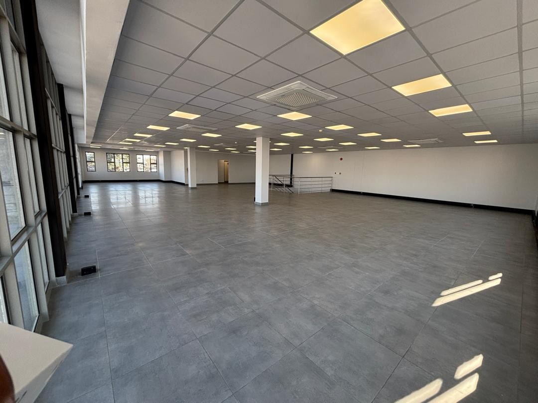 Refurbished open-plan commercial office with tiled flooring and suspended ceiling